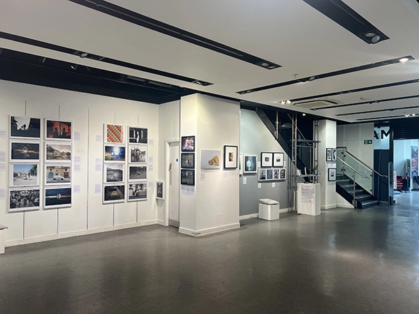 A wide-angle view of the main gallery space showcasing the Making Voices Heard photography collection.